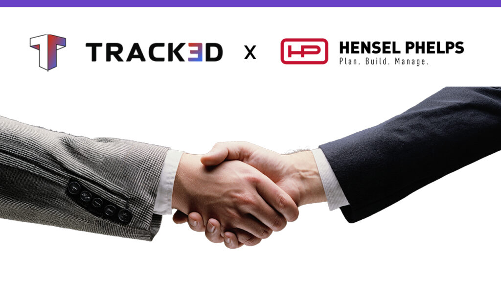 Handshake between business professionals with the Tracked and Hensel Phelps logos above, representing a partnership.