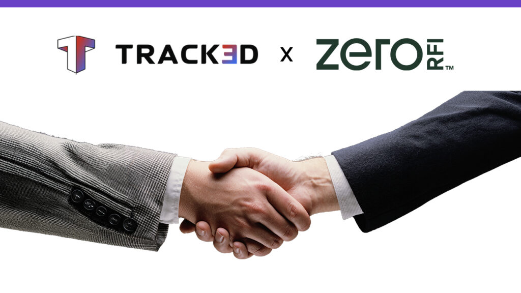 Handshake between two executives beneath the TRACKED x ZERO RIFT collaboration logo on a white background, suggesting a partnership.